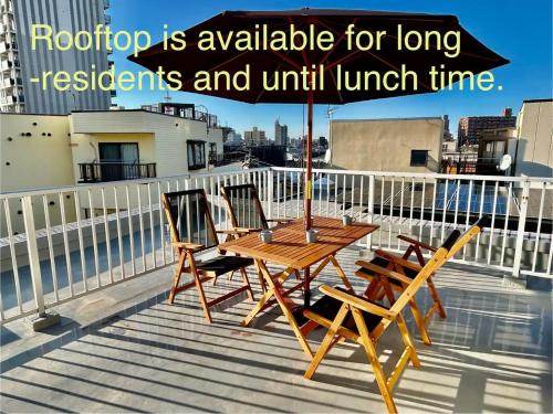a wooden table and two chairs on a balcony at Private Japanese garden,130m2, Ikebukuro Shinjuku Shibuya 5-15min , 200 restaurants nearby, 7-11 in front in Tokyo