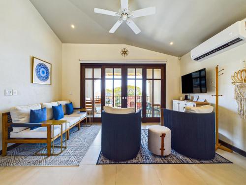 a living room with a couch and a ceiling fan at Miraflores 42 Ocean View Condo At Las Catalinas in Playa Danta
