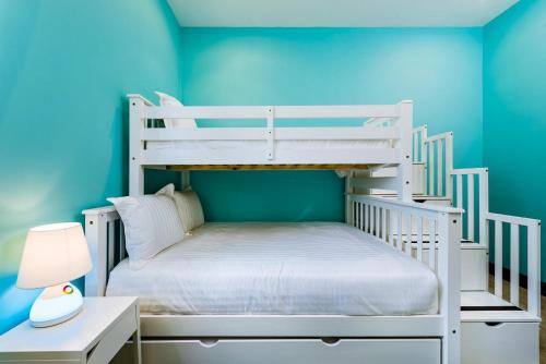 a white bunk bed in a room with blue walls at Plaza Carlota 2 At Las Catalinas in Playa Danta
