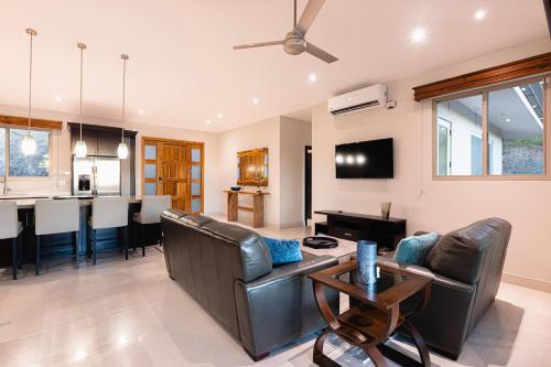 a living room with a couch and a table at Casa De Los Sueños, Brand New Ocean View Home On 125 Acres! in Brasilito
