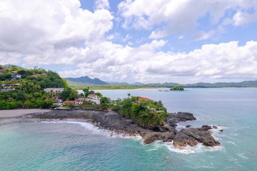 an island in a body of water with houses at Casa De Los Sueños, Brand New Ocean View Home On 125 Acres! in Brasilito