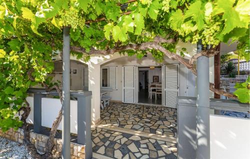 a view of the entrance to a house with a tree at 2 Bedroom Awesome Apartment In Rtina in Rtina