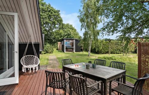a patio with a table and chairs on a deck at Cozy Home In Hejls With Wifi in Hejls