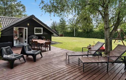 a deck with chairs and tables and a playground at Cozy Home In Hejls With Wifi in Hejls