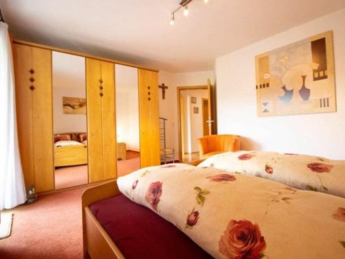 a bedroom with two beds and a mirror at Ferienhof Mayer - Apartment 4 in Lautenbach