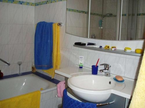 a bathroom with a sink and a bath tub and a sink at Ferienhof Mayer - Apartment 4 in Lautenbach