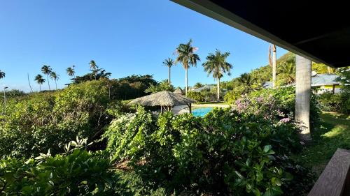 a view of a resort with a pool and palm trees at Moemiti in Moorea