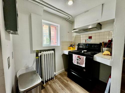 a small kitchen with a stove and a sink at Private Room with Shared Bathrooms 10 Minutes To SeaTac Airport in Seattle