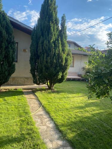 a yard with two trees and a house at Deers in Bansko