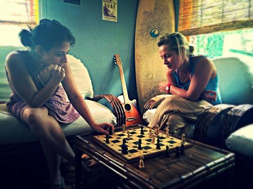 two women sitting on a couch playing a game of chess at Madagascar Underground in Antananarivo