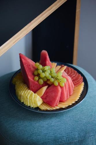 a plate of fruit on a blue table at Neve Eilat Hotel By Atlas Hotels in Eilat