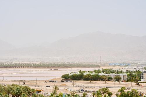 a view of a desert with a mountain in the background at Neve Eilat Hotel By Atlas Hotels in Eilat