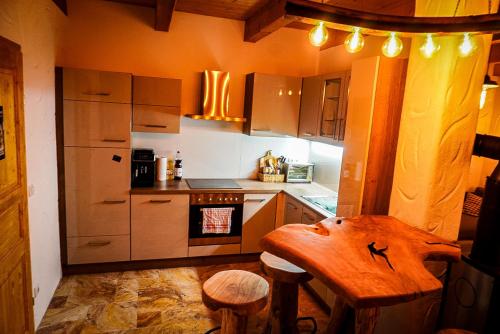 a kitchen with a wooden table and a stove at Weinkeller Gehringer in Guntersdorf