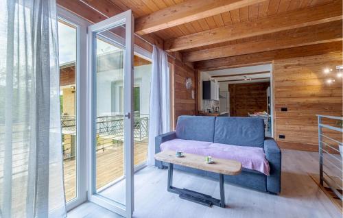 a living room with a blue couch and a table at Stunning Home In Chiusa Di Pesio in Chiusa di Pesio
