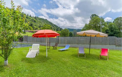 a group of chairs and umbrellas in a yard at Stunning Home In Chiusa Di Pesio in Chiusa di Pesio