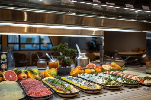 a buffet line with many different types of food at Neve Eilat Hotel By Atlas Hotels in Eilat