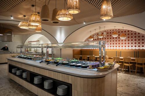 a buffet line in a restaurant with some food at Neve Eilat Hotel By Atlas Hotels in Eilat