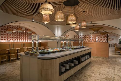 a buffet line in a restaurant with lights at Neve Eilat Hotel By Atlas Hotels in Eilat