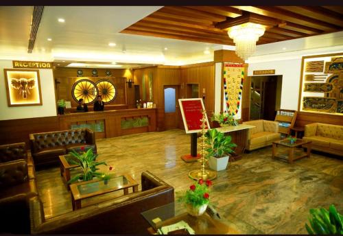 a living room with couches and chairs in a lobby at Paray Village County in Kollengode