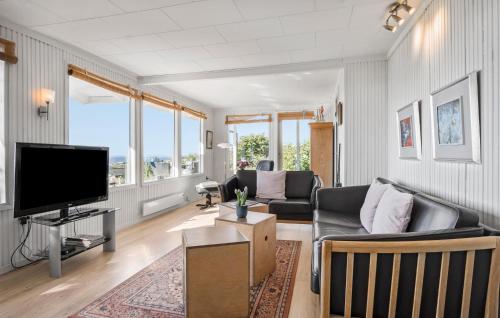 a living room with a couch and a flat screen tv at Fyrrehuset in Helnæs By