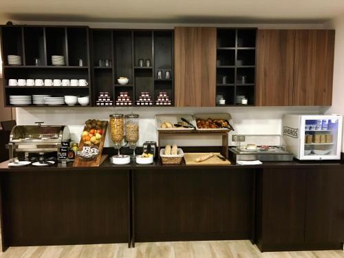 a kitchen with a counter with food on it at Brit Hotel Martigues Nord in Martigues