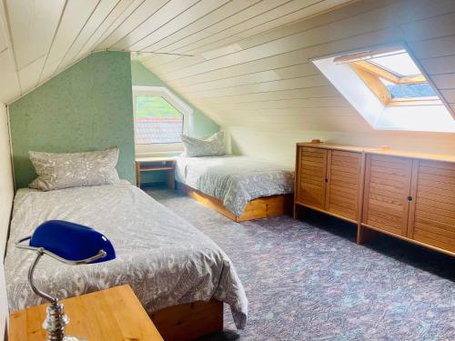 a attic bedroom with two beds and a skylight at Ferienwohnungen Klaß in Alken