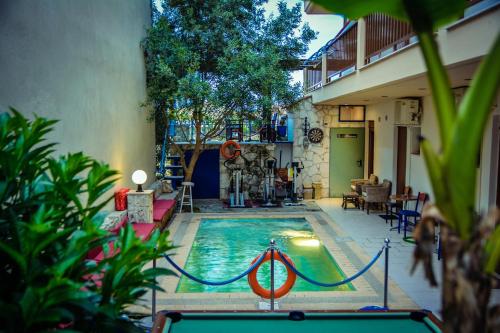 a swimming pool in the middle of a house at Erifili House in Kallithea Halkidikis