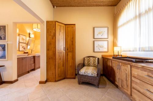 a bathroom with a sink and a chair in a room at Casa Rosa- Luxury Ocean View 3 Bedroom Home in Brasilito