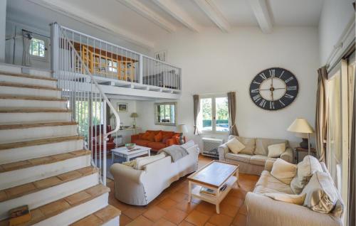 a living room with a staircase and a clock at Gorgeous Home In Callian With Wifi in Callian