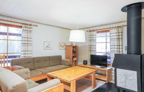 a living room with a couch and a table at Awesome Home In Lofsdalen With Sauna in Lofsdalen