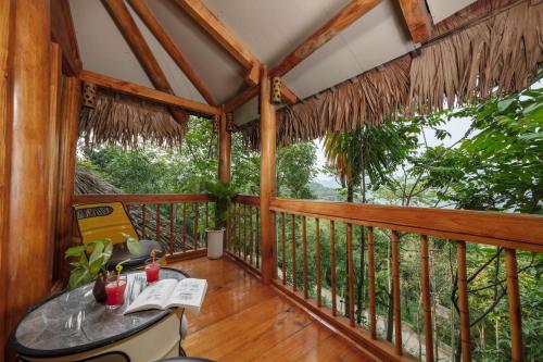 a room with a table on a balcony at Gateway Inn Puluong in Pu Luong