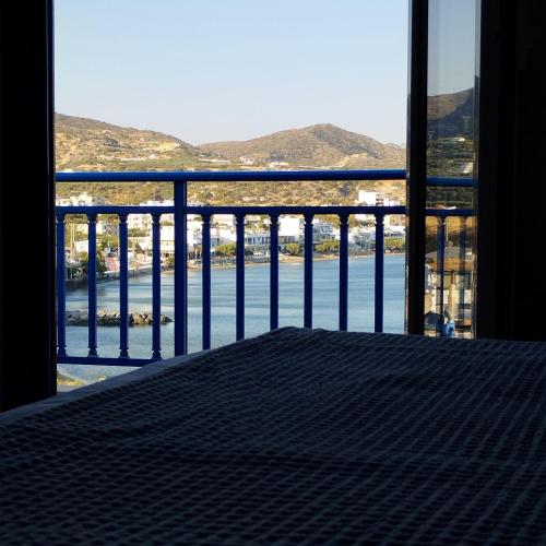 a room with a balcony with a view of the water at Light Blue in Makry Gialos