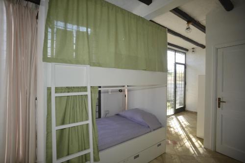 a bedroom with a bunk bed in a room at Kite Hostel Stagnone in Marsala