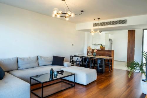 a living room with a couch and a table at Gioma Luxury Suites - Lake View - Jacuzzi in Agios Nikolaos