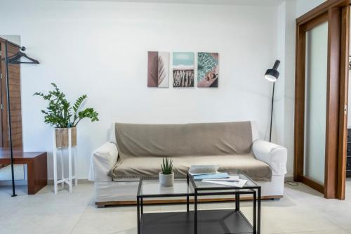 a living room with a couch and a table at Gioma Luxury Suites - Lake View - Jacuzzi in Agios Nikolaos
