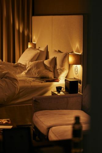 a bedroom with a bed and a table with a lamp at NOHGA HOTEL UENO TOKYO in Tokyo