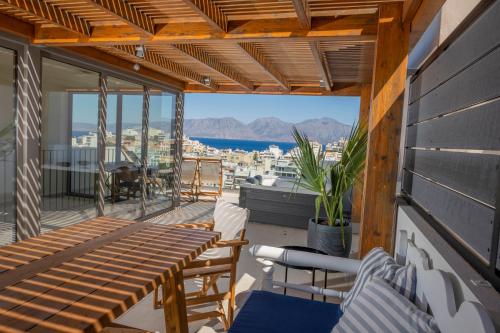 a balcony with a view of the city and the ocean at Gioma Luxury Suites - Lake View - Jacuzzi in Agios Nikolaos