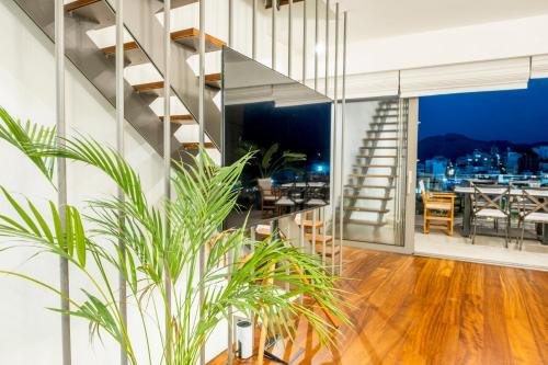 a living room with a staircase and a dining room at Gioma Luxury Suites - Lake View - Jacuzzi in Agios Nikolaos