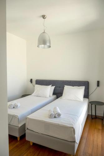 two beds sitting next to each other in a room at Gioma Luxury Suites - Lake View - Jacuzzi in Agios Nikolaos