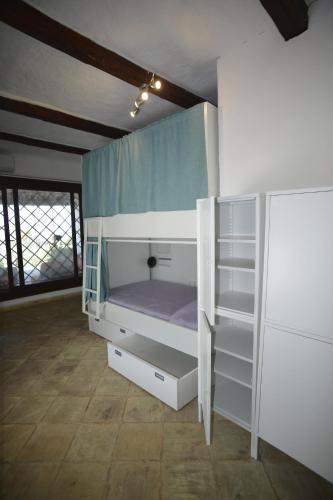a bedroom with a bunk bed in a room at Kite Hostel Stagnone in Marsala