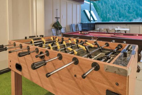 a large wooden board with locks on it with pool tables at Lakeview Splendor- 7BR Penthouse Bliss Combo unit in Harrison Hot Springs