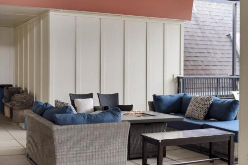 a patio with couches and a table and chairs at Lakeview Splendor- 7BR Penthouse Bliss Combo unit in Harrison Hot Springs