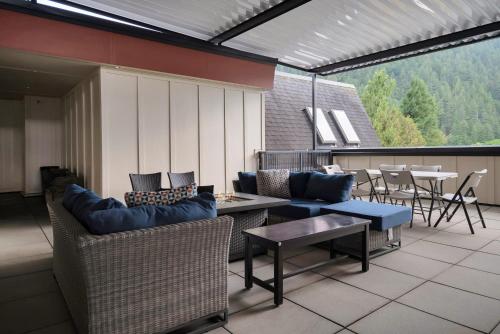 an outdoor patio with chairs and a table and a tableablish at Lakeview Splendor- 7BR Penthouse Bliss Combo unit in Harrison Hot Springs