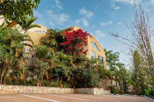 a building with red flowers on the side of it at High Ground Villa Ltd in Kigali