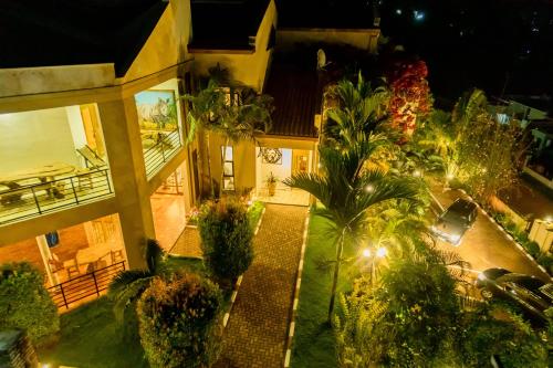 an aerial view of a house with palm trees and lights at High Ground Villa Ltd in Kigali