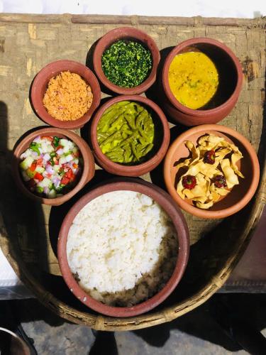 a group of bowls filled with different types of food at The Forest Edge Resort in Dambulla