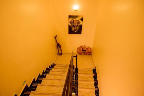 a set of stairs in a room with a guitar at High Ground Villa Ltd in Kigali