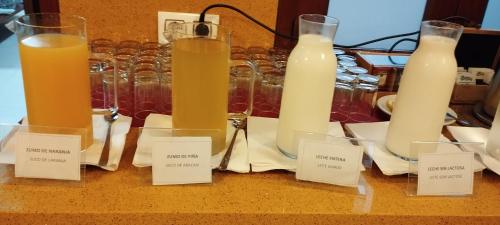 a bunch of candles sitting on a table with labels at Hotel Torres Touriño in Sanxenxo