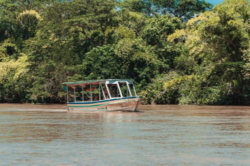 a boat in the water on a river at Plaza Carlota 2 At Las Catalinas in Playa Danta