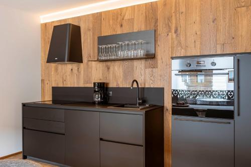 a kitchen with a counter top and a refrigerator at Chalet 104 Westendorf by ALPS RESORTS in Westendorf